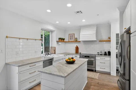 a kitchen with a stove a sink and a refrigerator