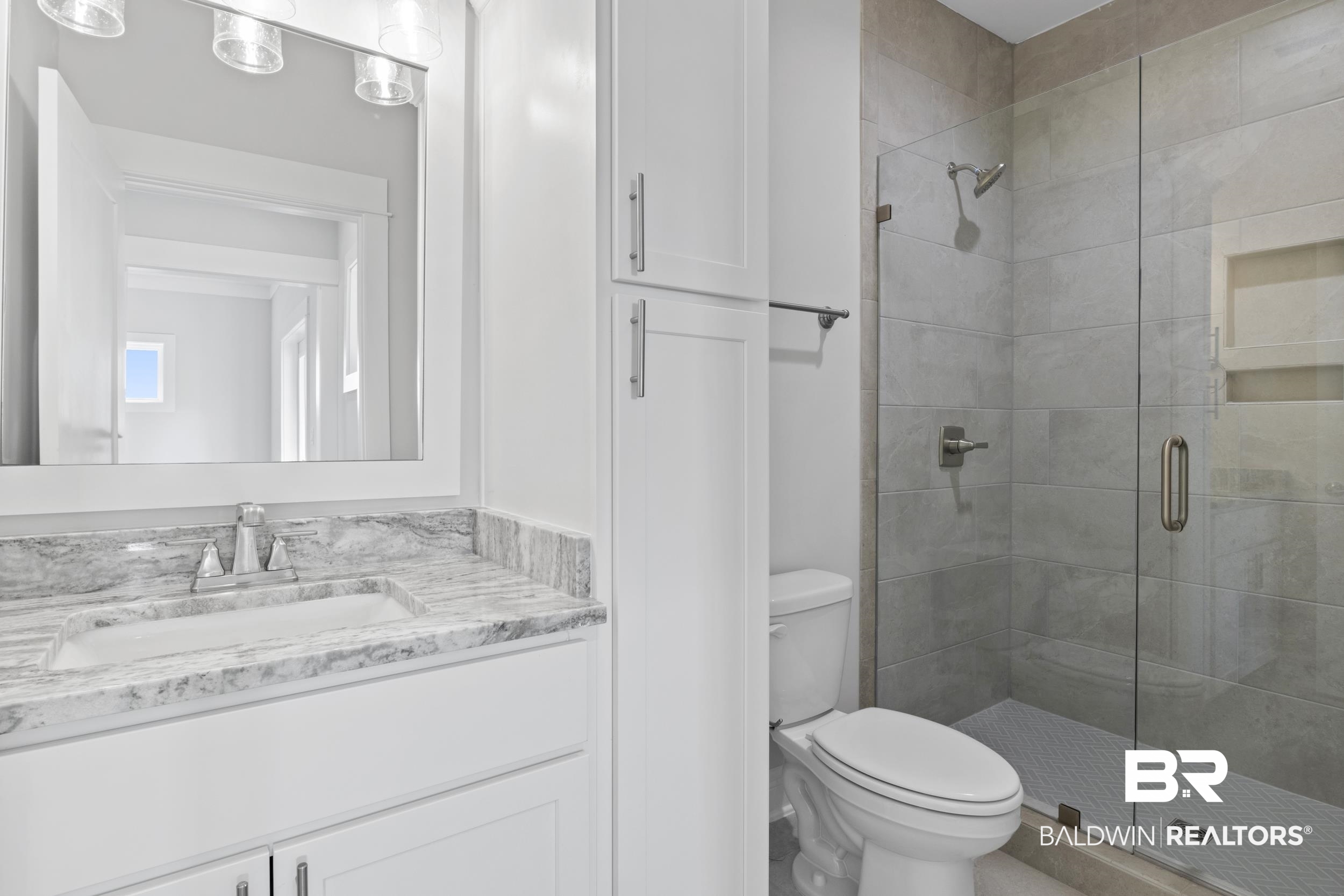 2847 Salt Drive Orange Beach, AL 36561 - Photo 22 of 29 Bathroom featuring vanity, toilet, and a shower with door