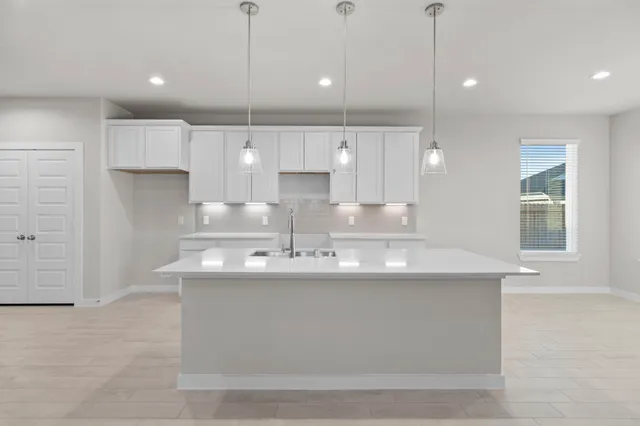 a kitchen with kitchen island a sink stainless steel appliances and cabinets