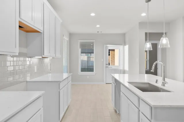 a kitchen with a sink stove and cabinets