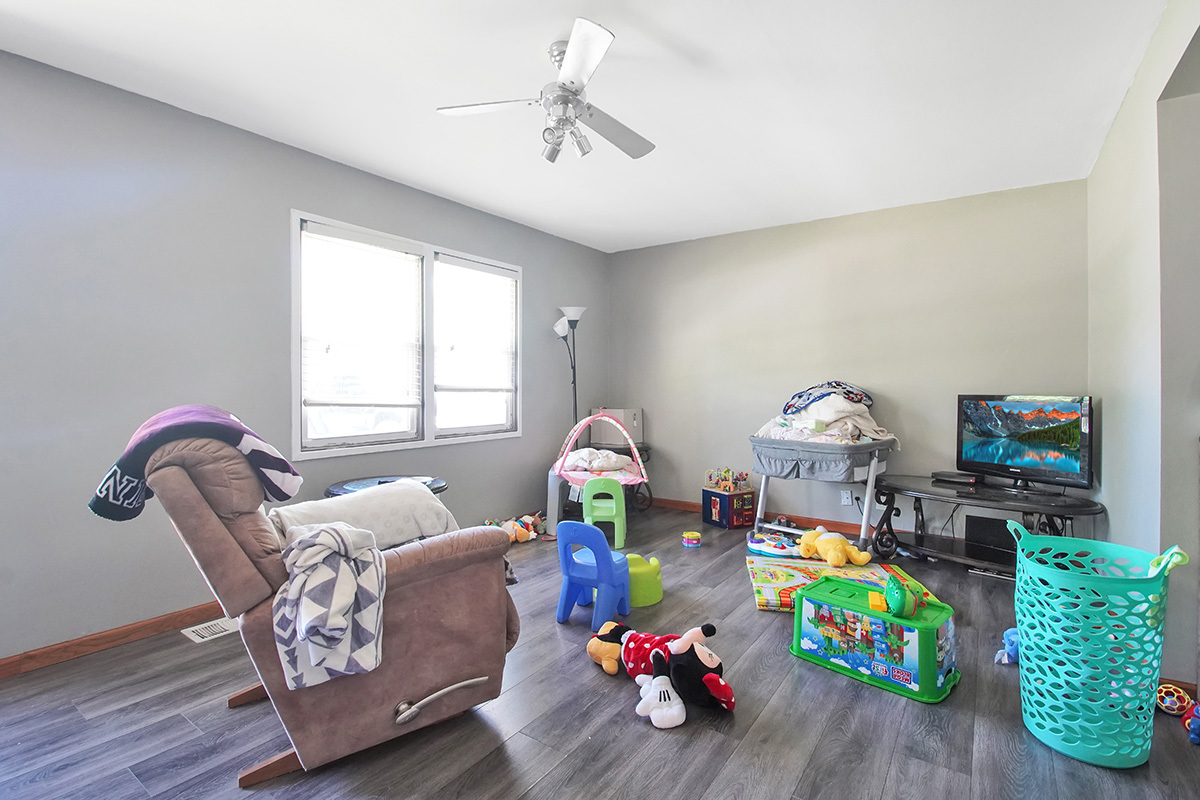 106 Louis Road Joliet, IL 60433 - Photo 4 of 14 a living room with furniture and a wooden floor