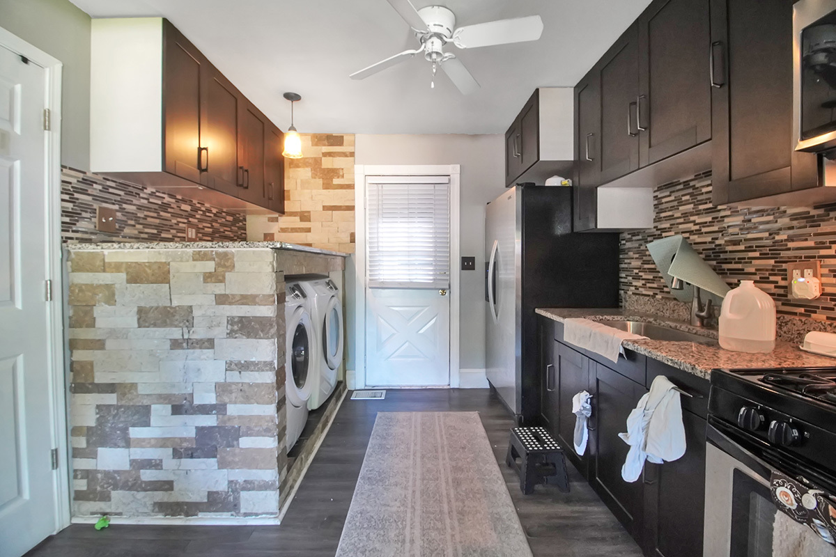 106 Louis Road Joliet, IL 60433 - Photo 6 of 14 a kitchen with granite countertop a refrigerator and a stove top oven