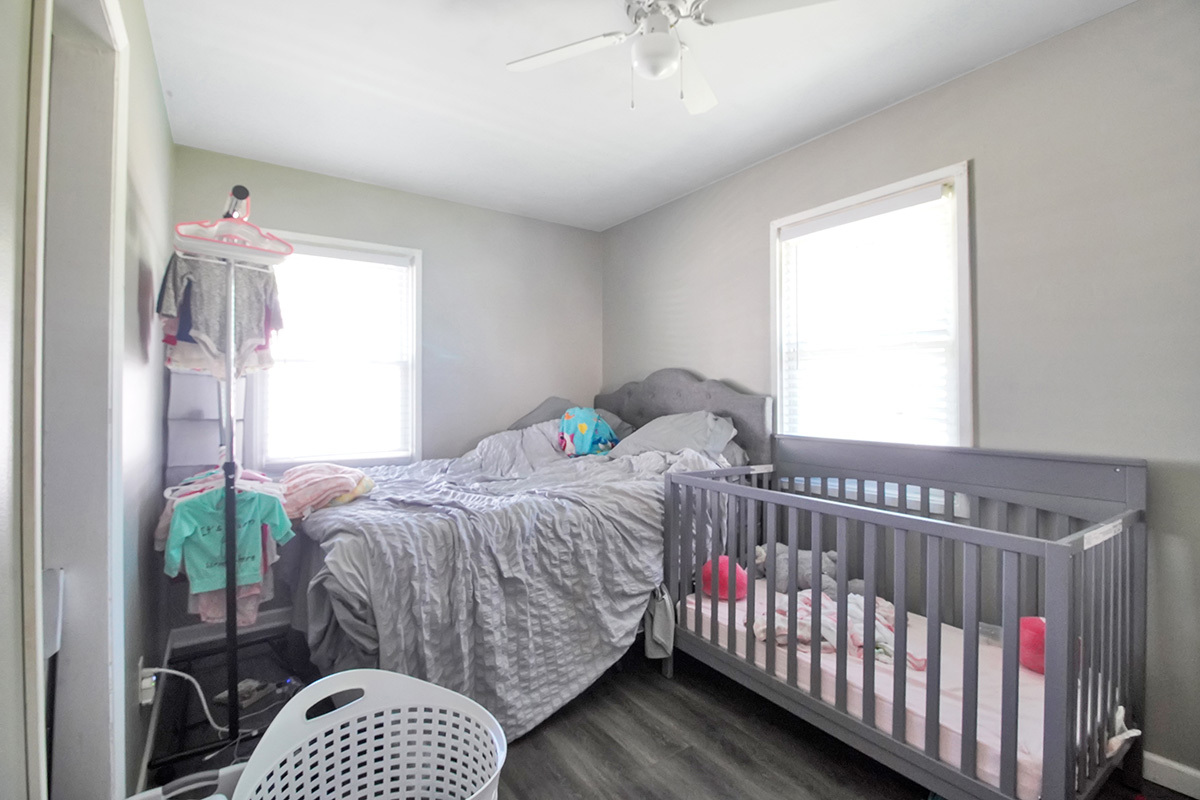 106 Louis Road Joliet, IL 60433 - Photo 8 of 14 a bedroom with a bed and a window