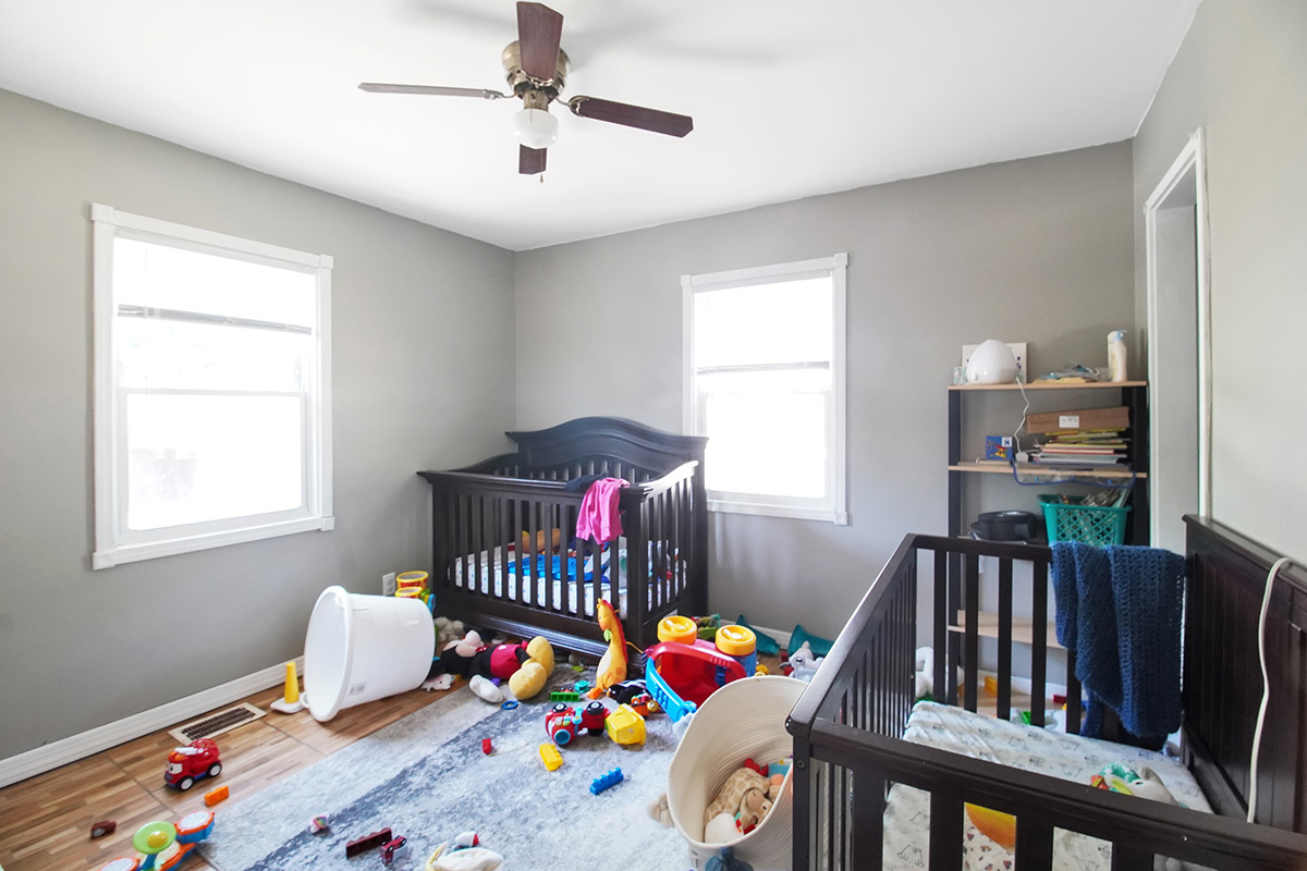 106 Louis Road Joliet, IL 60433 - Photo 10 of 14 a bedroom with furniture a baby crib and a window