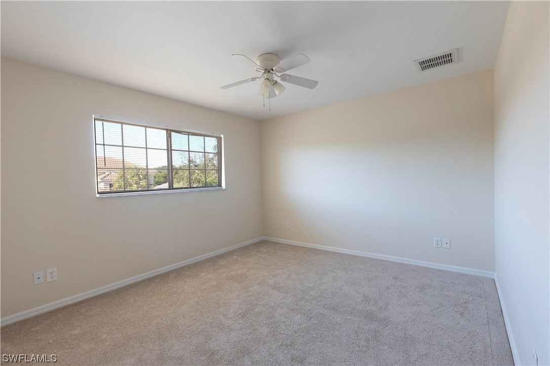 12956 Stone Tower Loop Fort Myers, FL 33913 - Photo 18 of 26 an empty room with windows and ceiling fan
