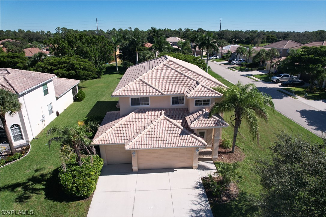 12956 Stone Tower Loop Fort Myers, FL 33913 - Photo 2 of 26 an aerial view of a house with a yard and trees