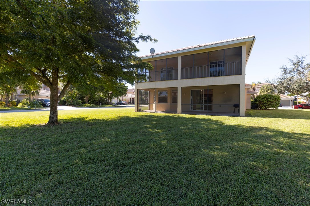 12956 Stone Tower Loop Fort Myers, FL 33913 - Photo 4 of 26 a view of a house with a swimming pool and a yard