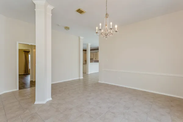a view of an empty room with a fireplace and a window