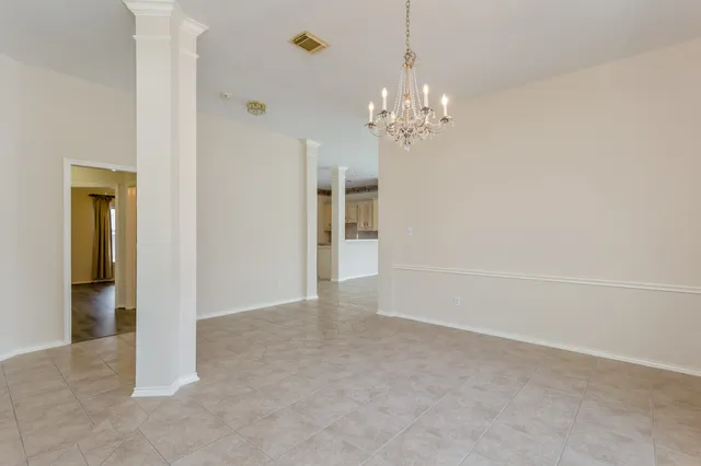 a view of an empty room with a fireplace and a window