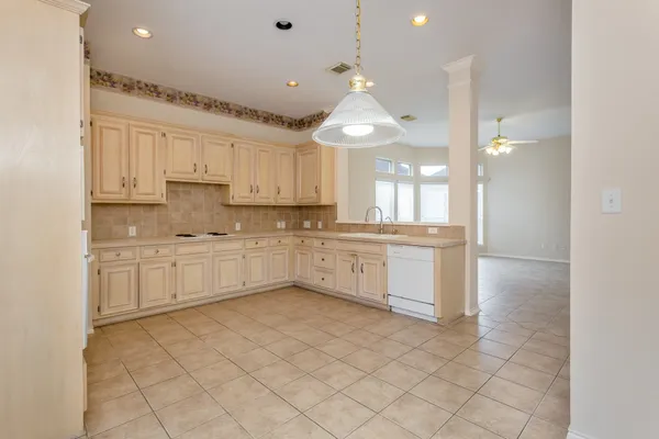 a kitchen with stainless steel appliances granite countertop a sink and cabinets