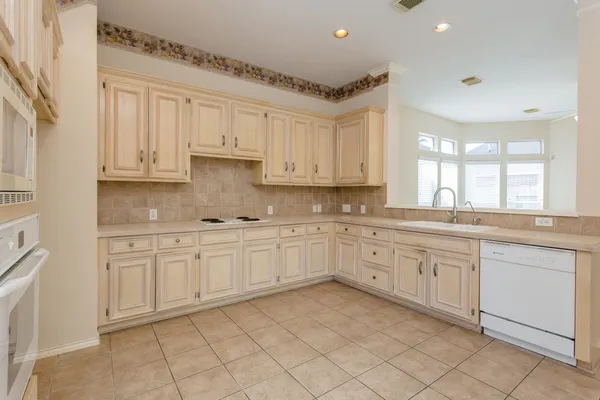 a kitchen with stainless steel appliances granite countertop a sink and cabinets