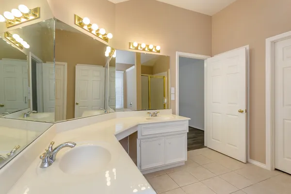 a bathroom with a tub sink and mirror