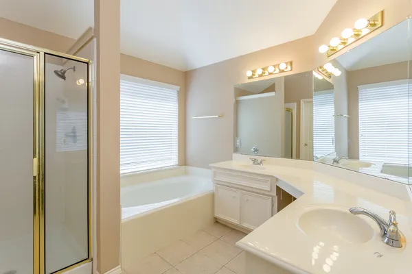 a bathroom with a bathtub and a shower
