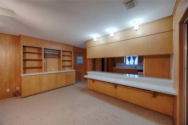 a living room with stainless steel appliances with large window