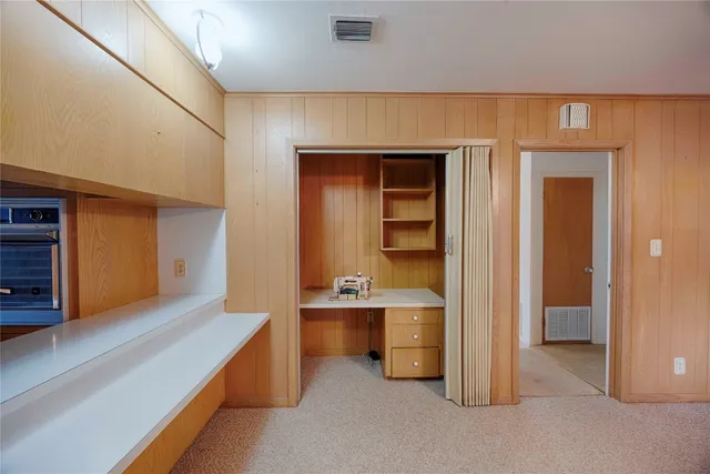 a view of an empty room and fire place