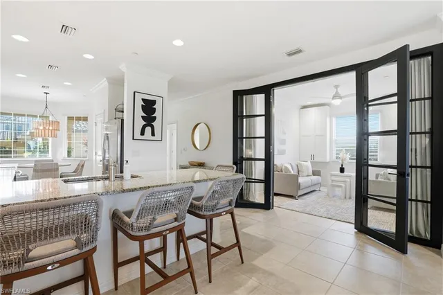 a very nice looking room with kitchen area and furniture