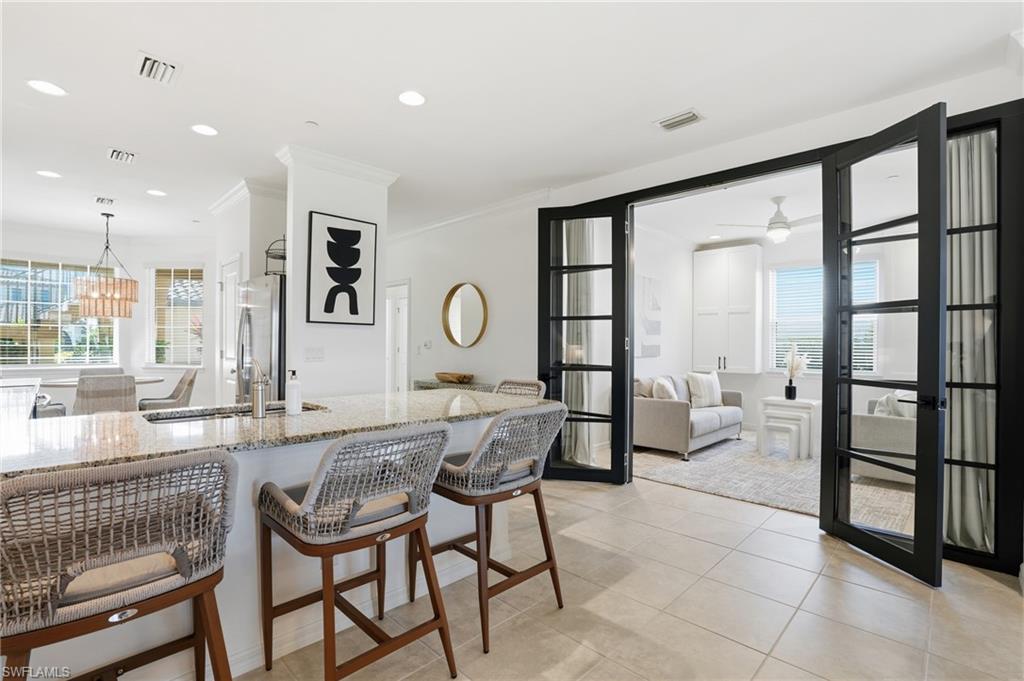 9374 Pocida Court, Unit 101 Naples, FL 34119 - Photo 14 of 32 a very nice looking room with kitchen area and furniture