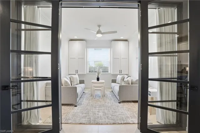 a living room with furniture and view of kitchen