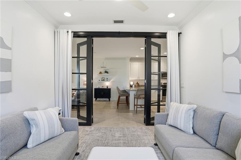 9374 Pocida Court, Unit 101 Naples, FL 34119 - Photo 16 of 32 a living room with furniture and view of kitchen
