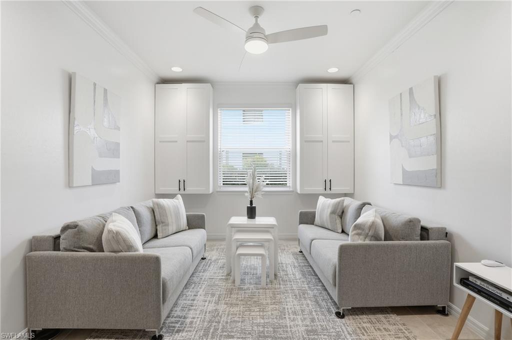 9374 Pocida Court, Unit 101 Naples, FL 34119 - Photo 17 of 32 a living room with furniture and a large window