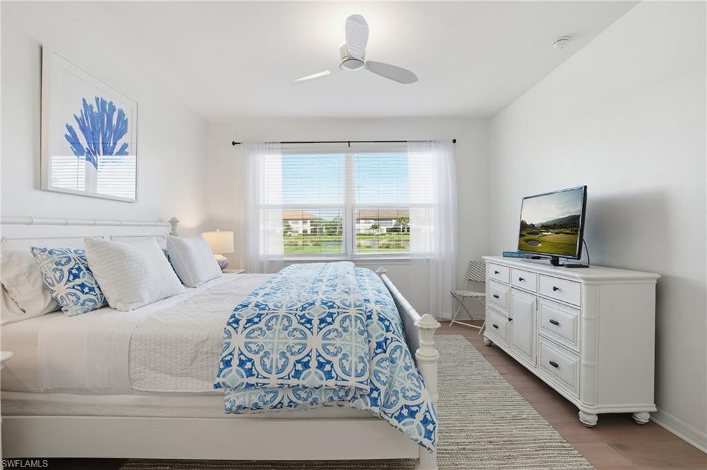 9374 Pocida Court, Unit 101 Naples, FL 34119 - Photo 18 of 32 a bedroom with a large bed and a window