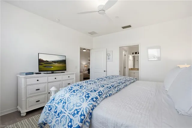 a bathroom with a granite countertop sink a toilet and shower