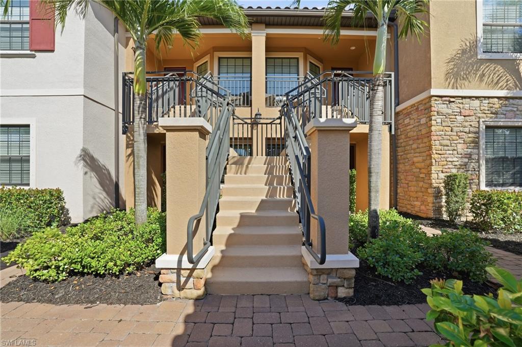 9374 Pocida Court, Unit 101 Naples, FL 34119 - Photo 25 of 32 a view of the house with many windows and plants
