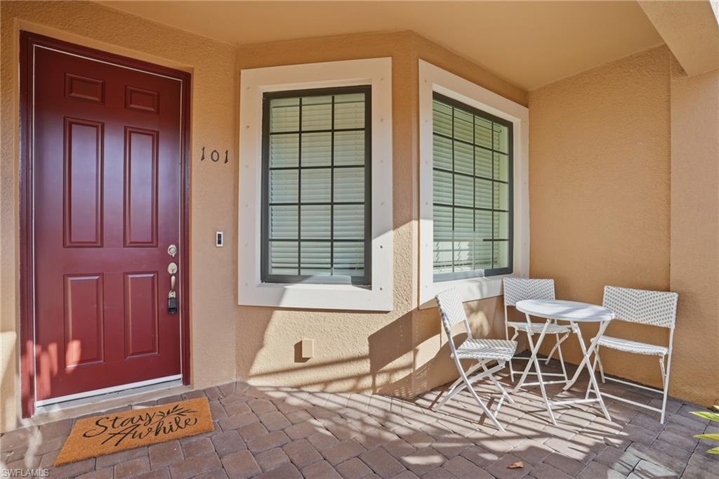9374 Pocida Court, Unit 101 Naples, FL 34119 - Photo 26 of 32 a living room with furniture and windows
