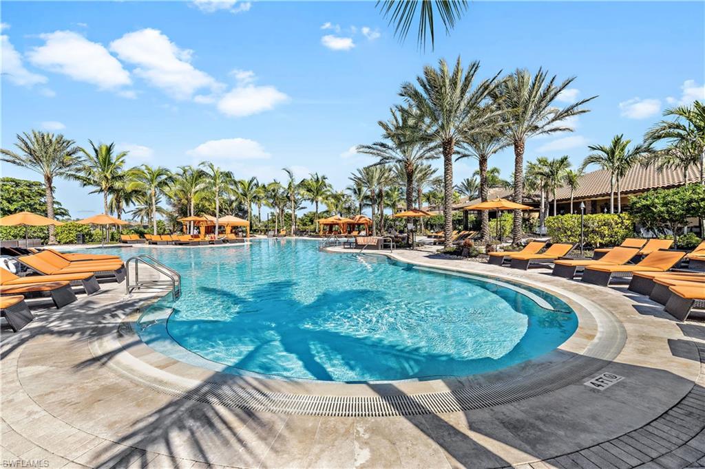 9374 Pocida Court, Unit 101 Naples, FL 34119 - Photo 28 of 32 a view of swimming pool with outdoor seating and plants