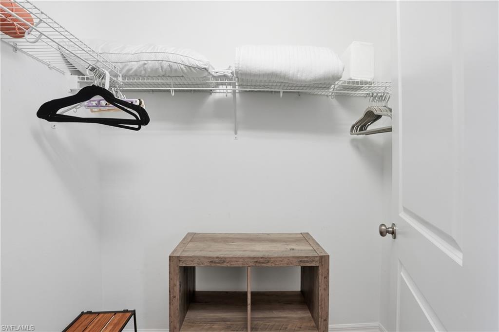 9374 Pocida Court, Unit 101 Naples, FL 34119 - Photo 31 of 32 a bathroom with a sink and cabinets