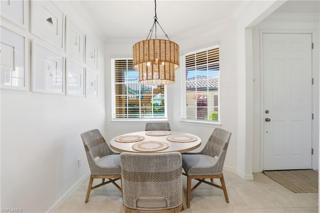 9374 Pocida Court, Unit 101 Naples, FL 34119 - Photo 4 of 32 a dining room with furniture and window