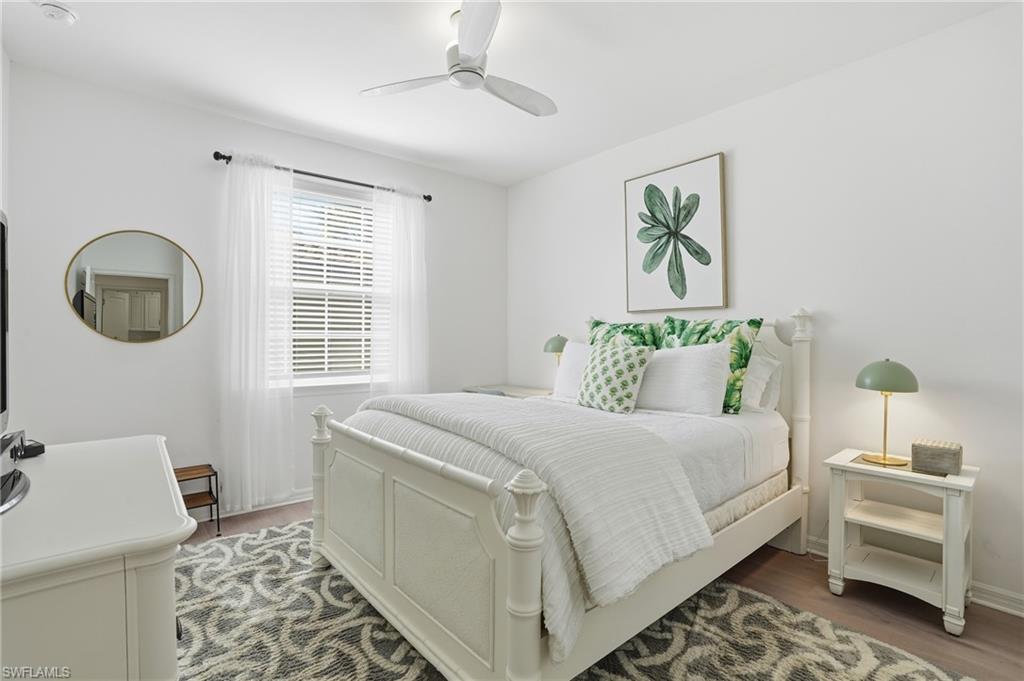 9374 Pocida Court, Unit 101 Naples, FL 34119 - Photo 6 of 32 a bedroom with a bed and a window