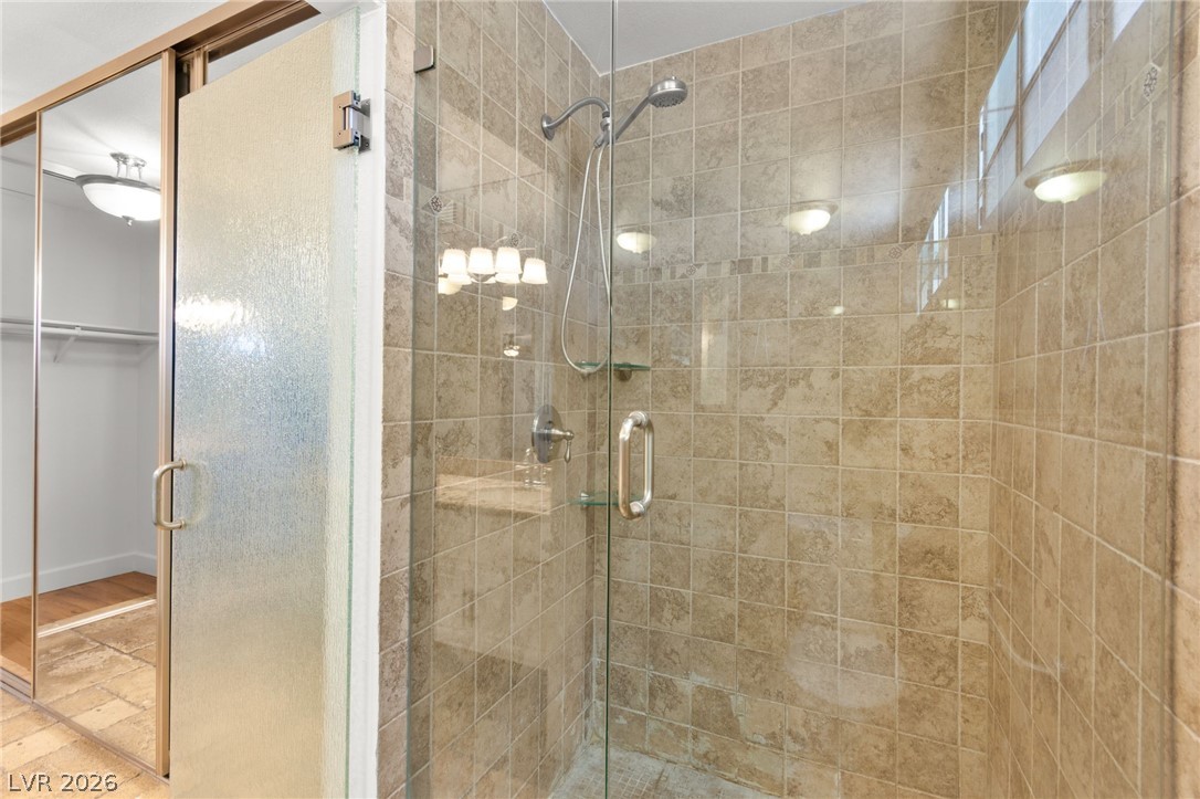 4430 Cranbrook Way Las Vegas, NV 89103 - Photo 40 of 50 A well-appointed shower stall features clear glass enclosure, tiled walls, and a modern fixture.