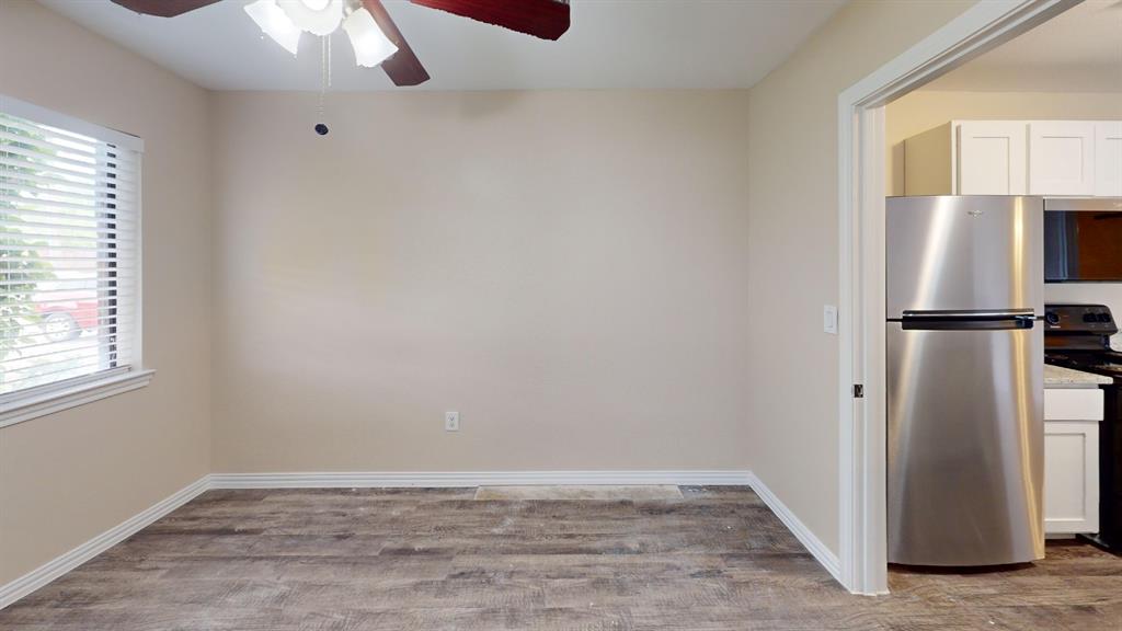 9837 Walnut Street, Unit 103 Dallas, TX 75243 - Photo 4 of 10 a view of kitchen with a refrigerator cabinets and wooden floor