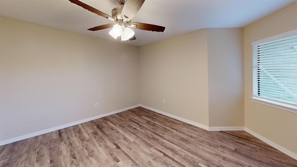 9837 Walnut Street, Unit 103 Dallas, TX 75243 - Photo 7 of 10 wooden floor in an empty room with a window