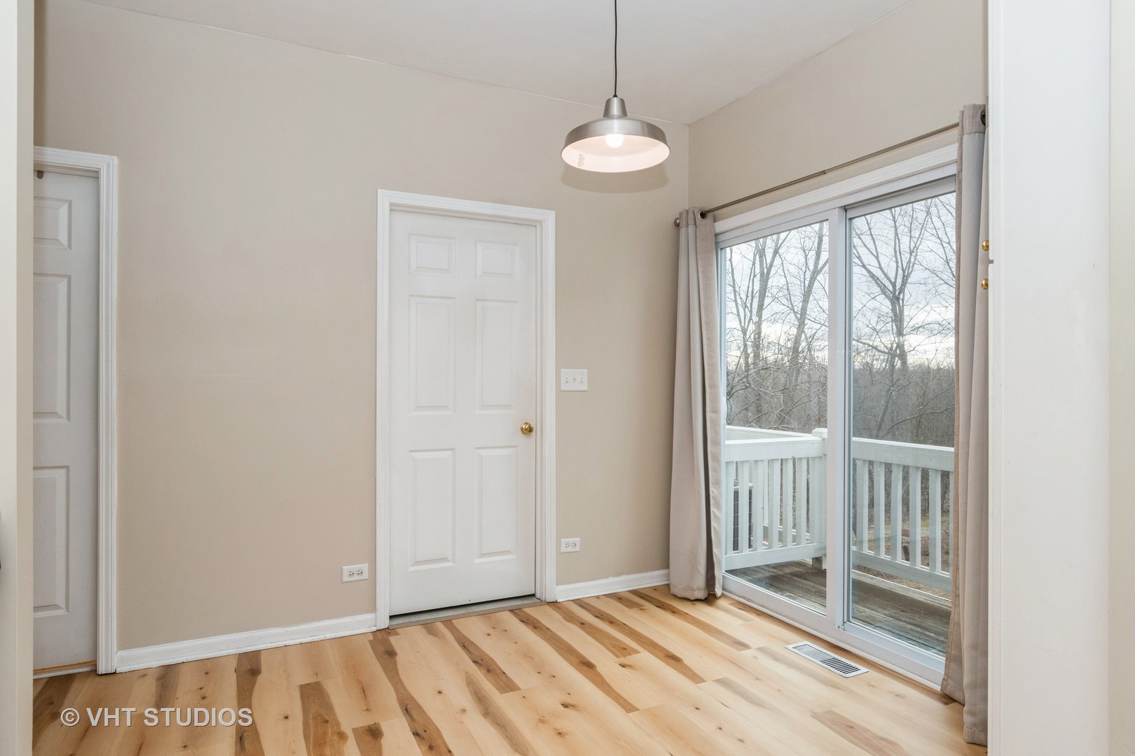 3499 Ravinia Circle Aurora, IL 60504 - Photo 5 of 20 a view of an empty room with wooden floor and a window