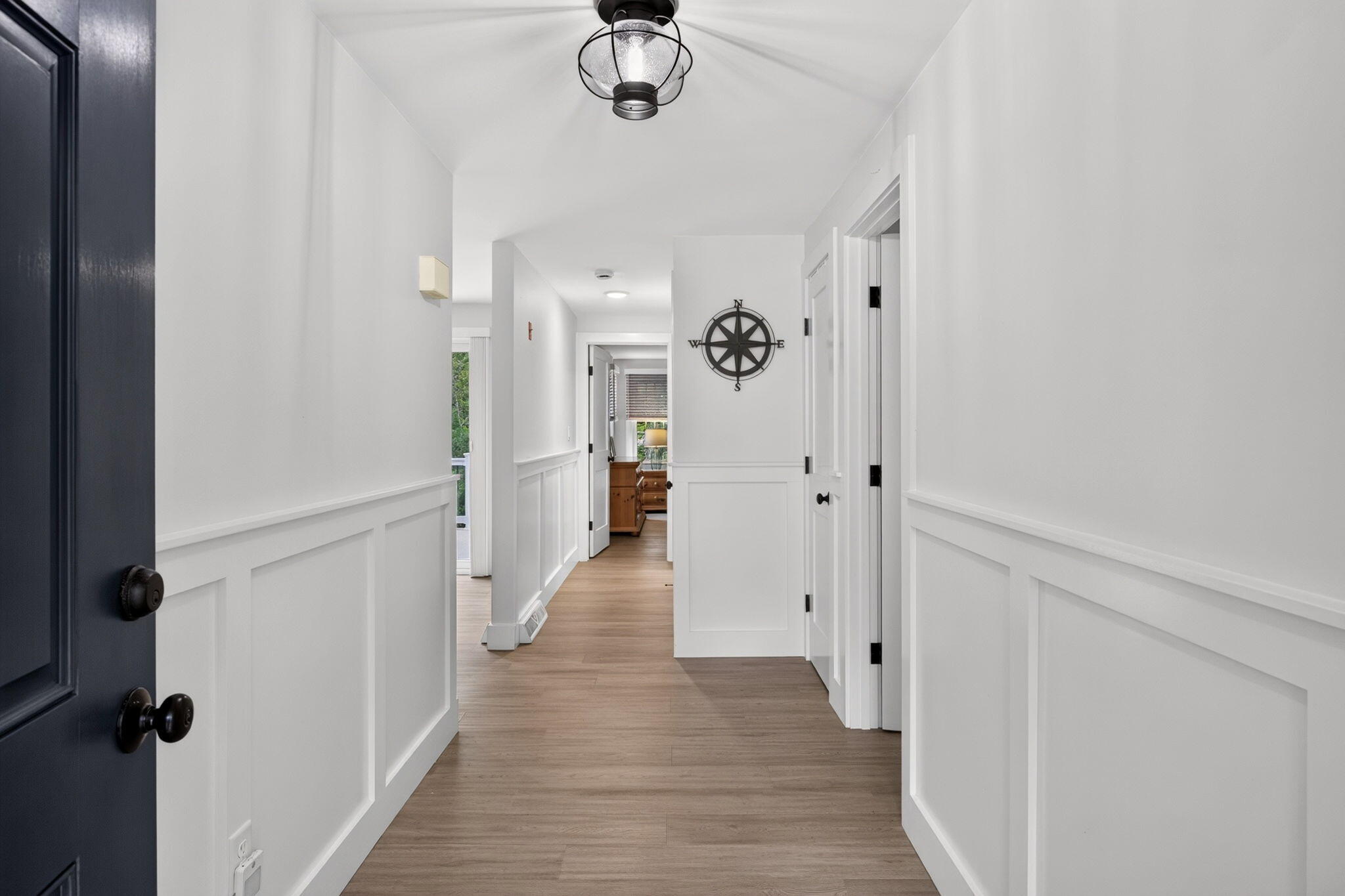 35 Debs Hill Road, Unit 35 Yarmouth Port, MA 02675 - Photo 3 of 36 a view of a hallway with wooden floor and chandelier