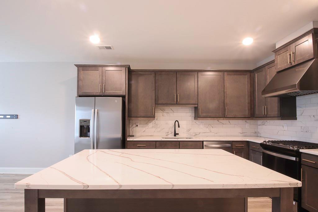 1345 Parc Bench Road Atlanta, GA 30316 - Photo 2 of 6 a kitchen with stainless steel appliances kitchen island granite countertop a refrigerator sink and cabinets