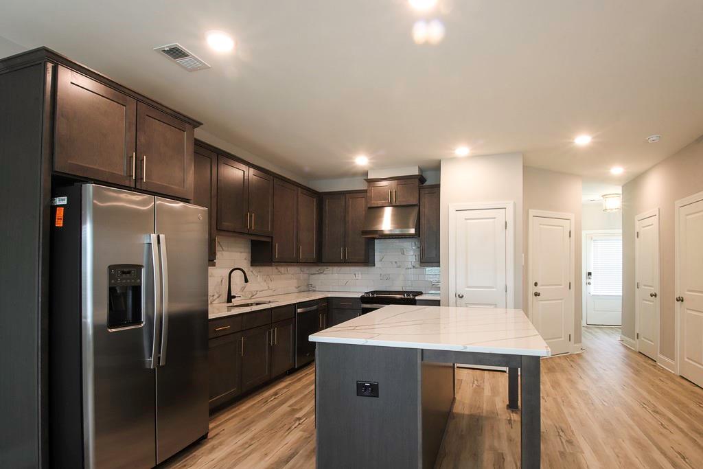 1345 Parc Bench Road Atlanta, GA 30316 - Photo 3 of 6 a kitchen that has a sink a refrigerator and cabinets