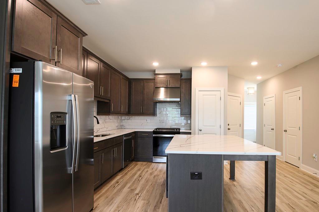 1345 Parc Bench Road Atlanta, GA 30316 - Photo 6 of 6 a kitchen with stainless steel appliances kitchen island granite countertop a sink refrigerator and cabinets