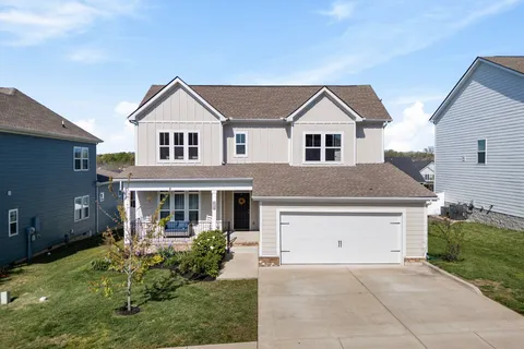 a front view of house with yard and green space