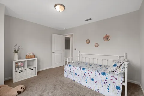 a bedroom with furniture and a book shelf