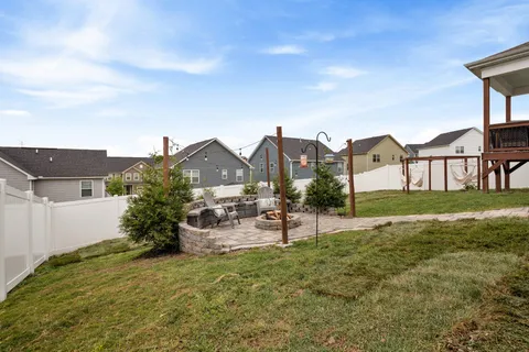 a view of a house with a yard and sitting area
