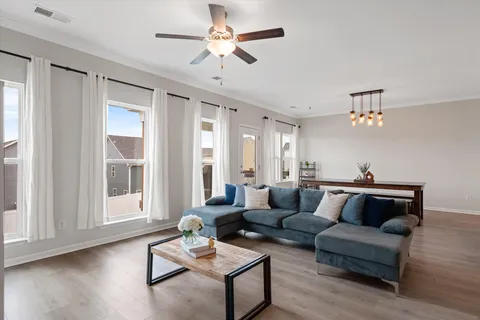 a living room with furniture and wooden floor