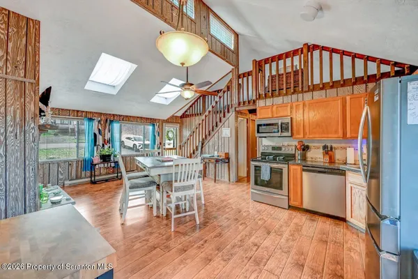 a dining room with furniture a chandelier and wooden floor