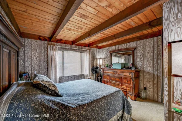 a bed sitting in a bedroom next to a window