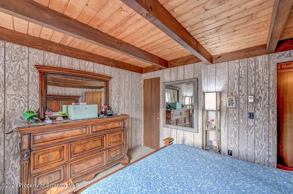 a bedroom with a bed and a large dresser