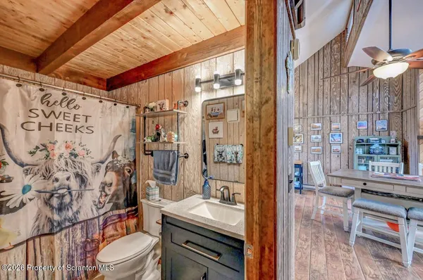 a bathroom with a sink toilet vanity and tub