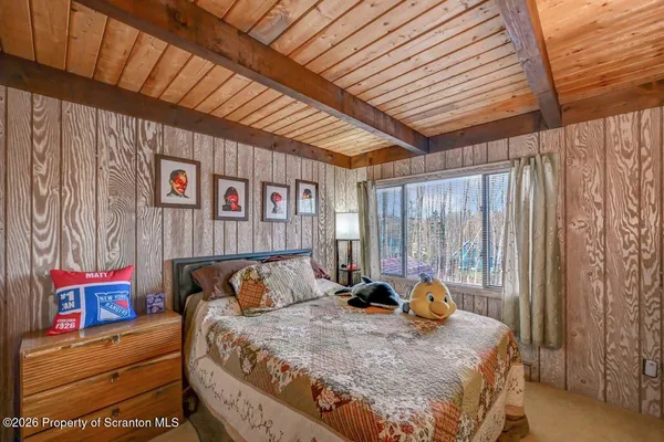 a bed sitting in a bedroom next to a bathroom