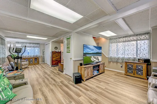 a living room with a couch and a wooden floor